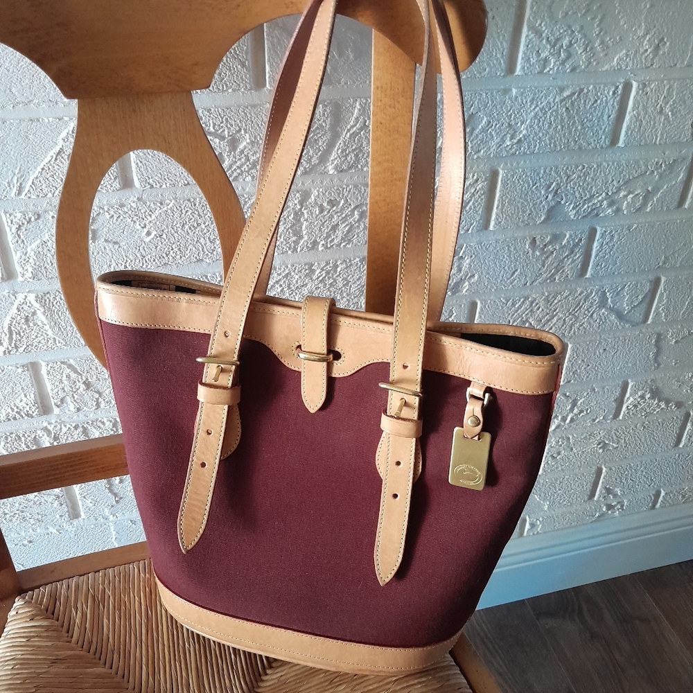 Dooney & Bourke burgundy canvas bag with leather straps.
